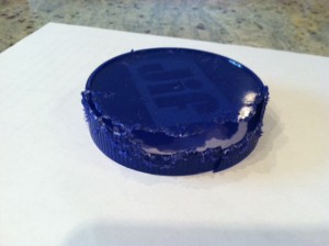 Bright blue plastic jar lid chewed up by a squirrel at Adventures in Expat Land